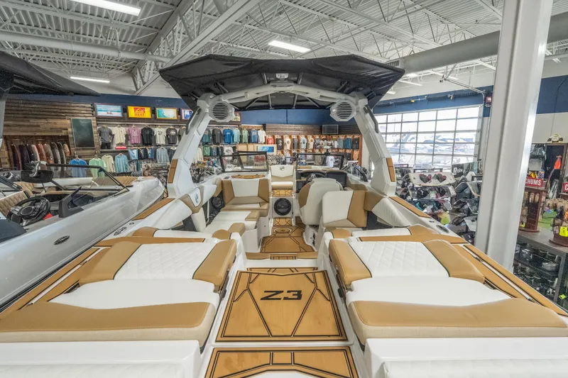 Slide: The Image of 2026 Tigé Z3 boat interior with luxurious seating in a showroom setting. - 10