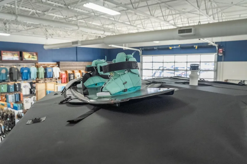 Slide: The Image of 2026 Tigé Z3 boat with teal wakeboard bindings in a showroom. - 14