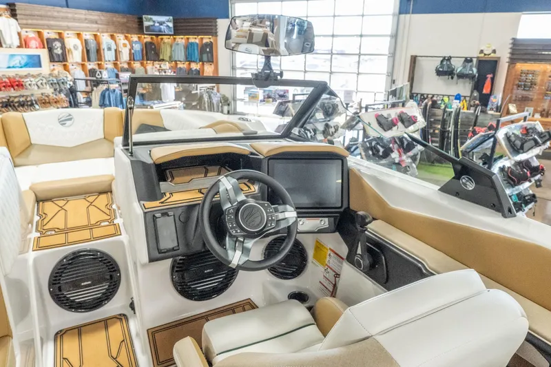 Slide: The Image of Interior of 2026 Tigé Z3 boat with modern dashboard and steering wheel in showroom. - 17