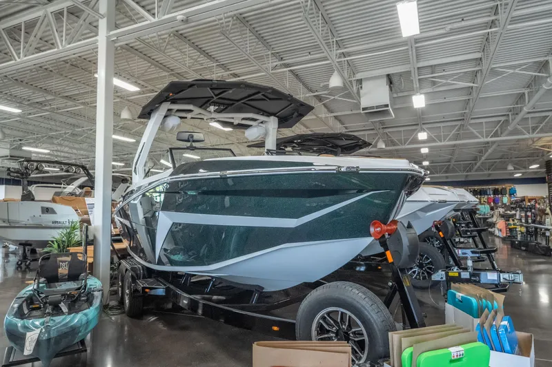 Slide: The Image of 2026 Tigé Z3 boat displayed in a showroom with sleek design and modern features. - 2