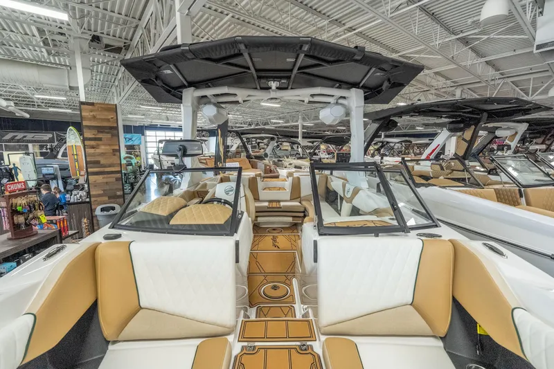 Slide: The Image of 2026 Tigé Z3 boat interior with luxurious seating and modern design in a showroom. - 22