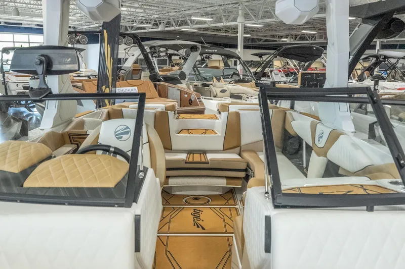 Slide: The Image of 2026 Tigé Z3 boat interior with luxurious seating and modern design in showroom. - 23