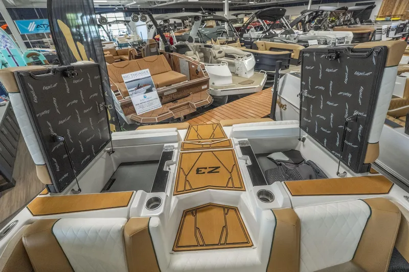 Slide: The Image of 2026 Tigé Z3 boat interior with open storage compartments in a showroom. - 28