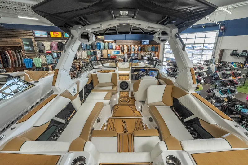 Slide: The Image of 2026 Tigé Z3 boat interior with luxurious seating and modern dashboard in a showroom. - 38