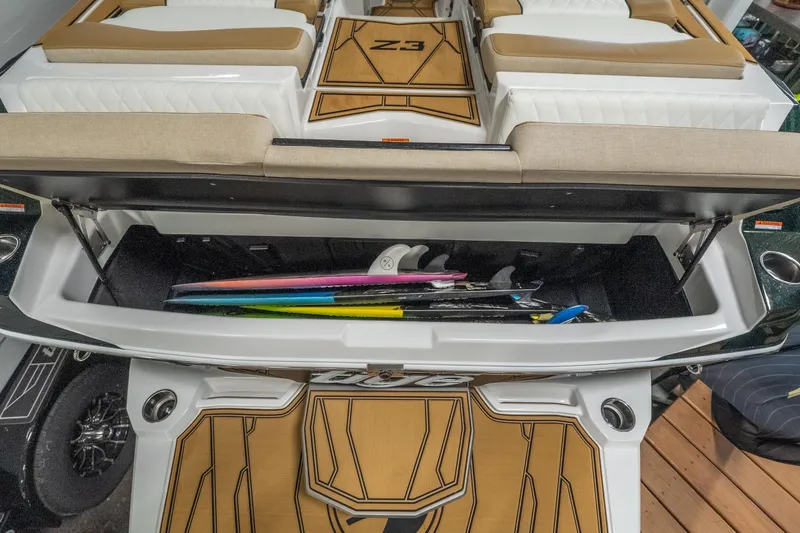 Slide: The Image of 2026 Tigé Z3 boat with open storage compartment holding colorful surfboards. - 9