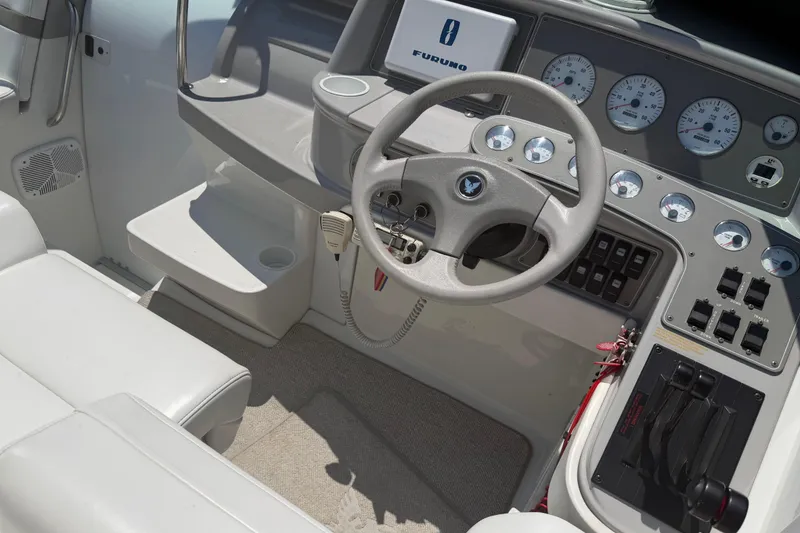 Slide: The Image of Interior cockpit of 2000 Formula 330 Sun Sport boat with steering wheel and control panel. - 13