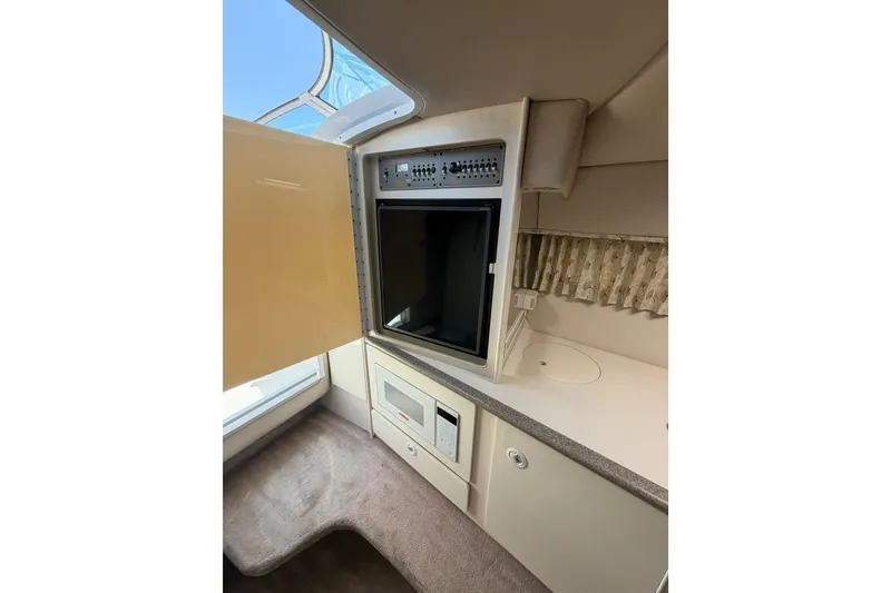 Slide: The Image of Interior of a 2000 Formula 330 Sun Sport boat with open cabinet and appliances. - 17