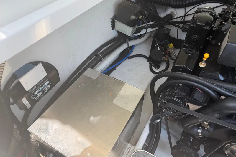 Slide: The Image of Engine compartment of a 2000 Formula 330 Sun Sport boat, showcasing mechanical components. - 22