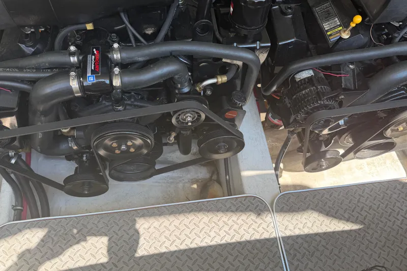 Slide: The Image of Engine compartment of a 2000 Formula 330 Sun Sport boat, showcasing dual engines and belts. - 24
