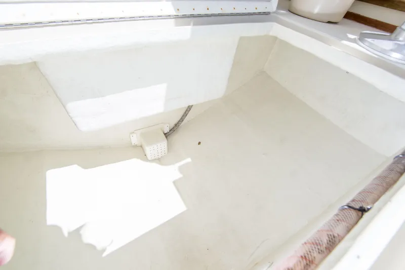 Slide: The Image of Interior view of a 2009 Blackman Pilothouse boat compartment, featuring clean white surfaces. - 29