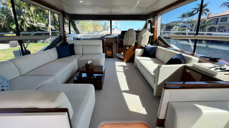 Slide: The Image of Luxurious interior of a 2019 Princess F62 yacht with elegant seating and panoramic windows. - 11