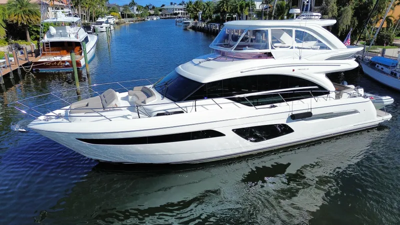 Slide: The Image of Luxurious 2019 Princess F62 yacht docked in a scenic marina. - 2