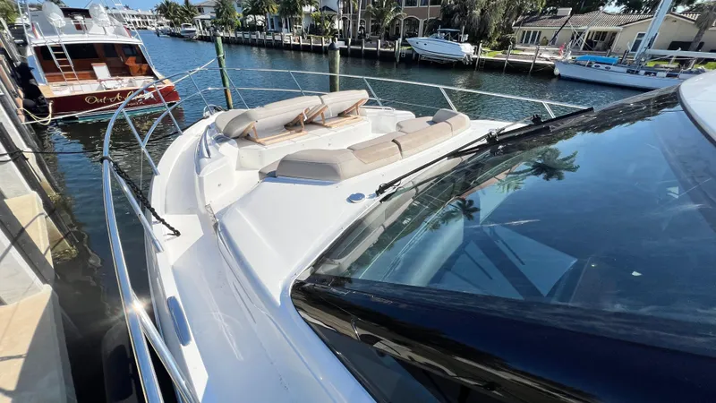 Slide: The Image of 2019 Princess F62 yacht docked in a marina, featuring spacious deck and luxurious seating. - 45
