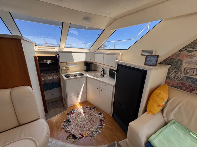 Slide: The Image of Interior of a Silverton 351 Sedan yacht with a kitchen and seating area. - 13