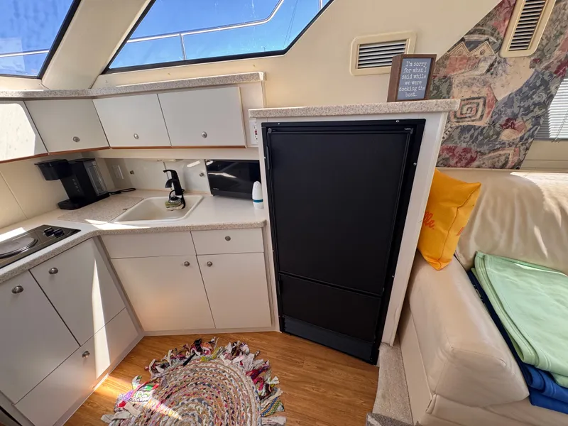 Slide: The Image of Interior of a Silverton 351 Sedan yacht with a kitchen and seating area. - 14