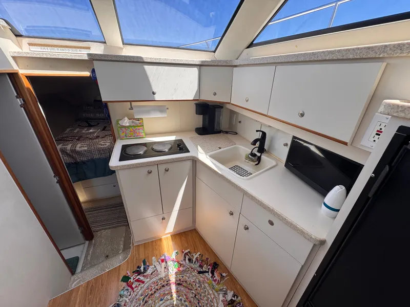 Slide: The Image of Interior of a Silverton 351 Sedan yacht with kitchen and sleeping area. - 15