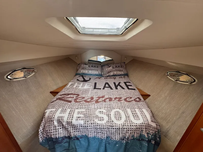 Slide: The Image of Interior of a Silverton 351 Sedan with a cozy bed and skylights. - 16