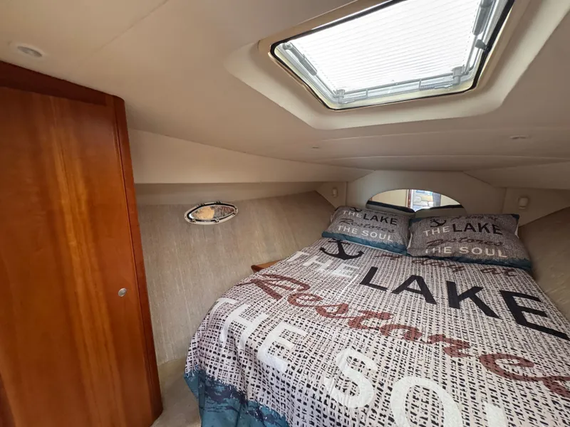 Slide: The Image of Interior of a Silverton 351 Sedan with a cozy bed and skylight. - 18
