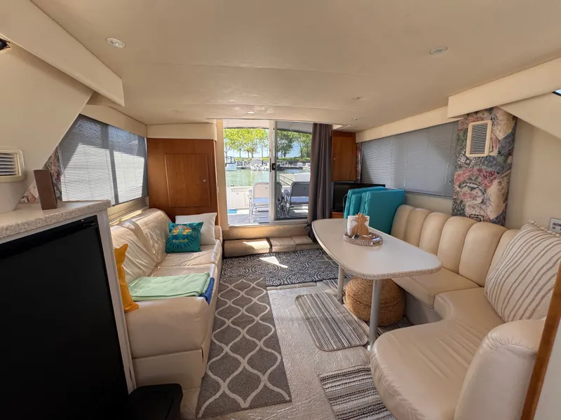 Slide: The Image of Interior of a Silverton 351 Sedan yacht with beige sofa and table. - 19