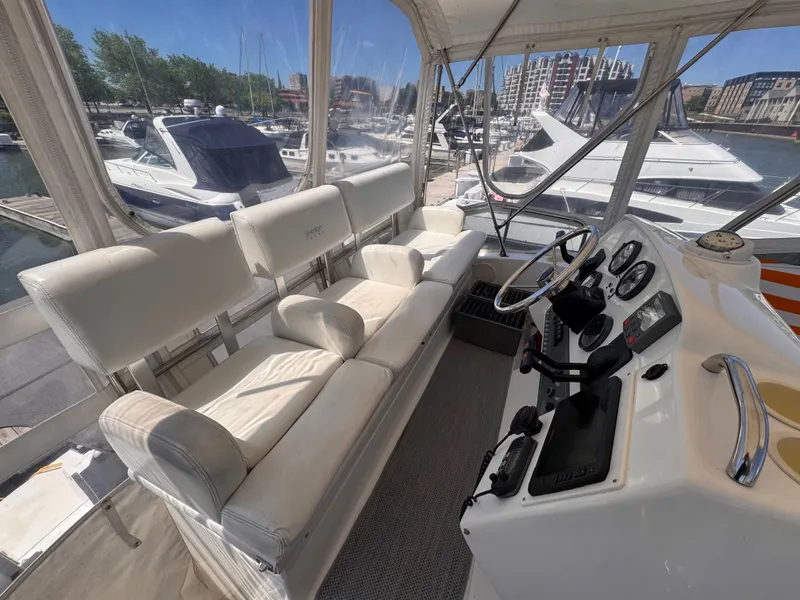 Slide: The Image of Interior of a Silverton 351 Sedan yacht with white leather seating and a control console. - 21