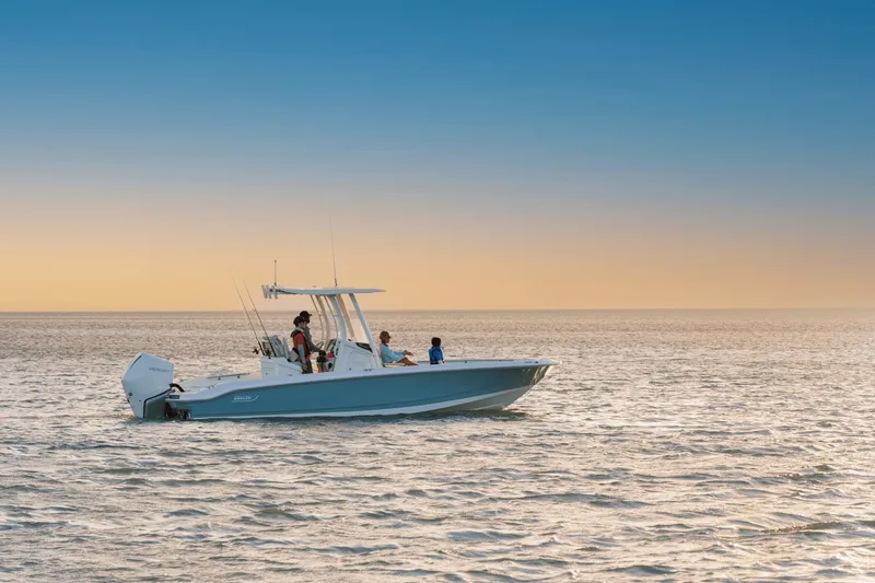 Slide: The Image of A 2027 Boston Whaler 250 Dauntless cruising on calm waters at sunset. - 8