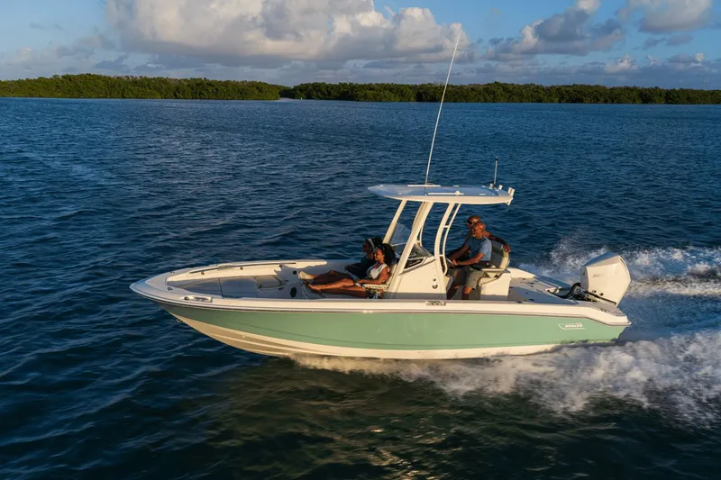 Slide: The Image of Boston Whaler 250 Dauntless from 2027 cruising swiftly on calm waters under a blue sky. - 27