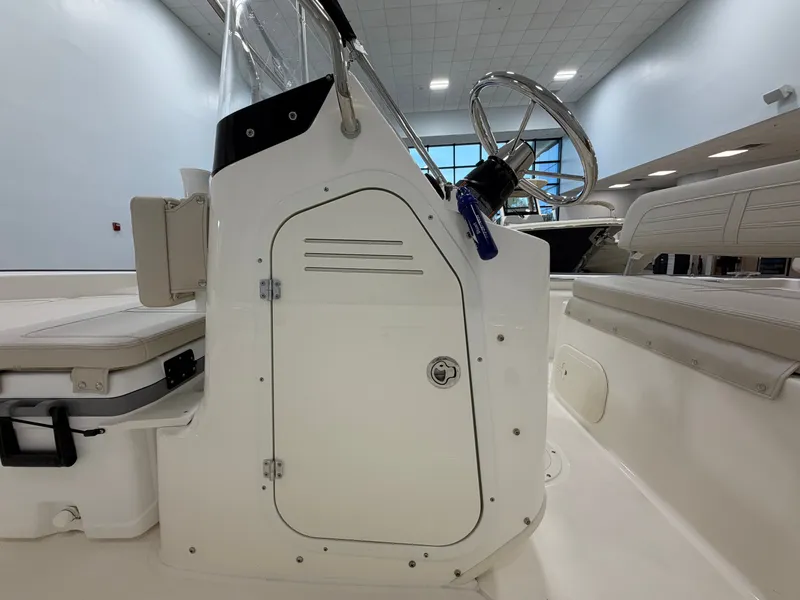 Slide: The Image of The image shows the cockpit of a Boston Whaler 170 Montauk with a helm and seating. - 16