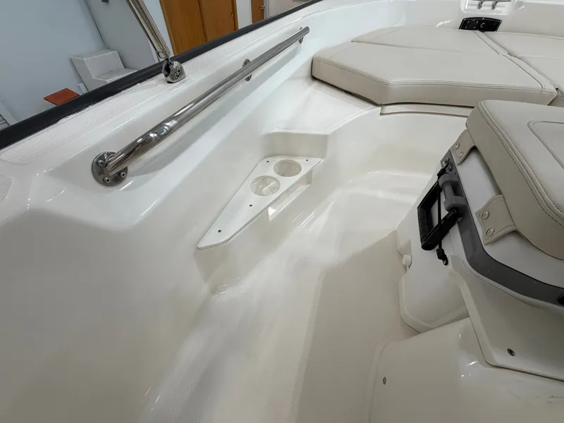 Slide: The Image of The image shows the interior of a Boston Whaler 170 Montauk boat with beige upholstery and stainless steel railing. - 28