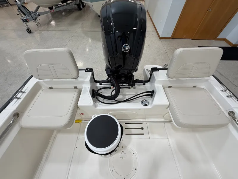 Slide: The Image of The image shows the stern of a Boston Whaler 170 Montauk with an outboard motor and two seats. - 27