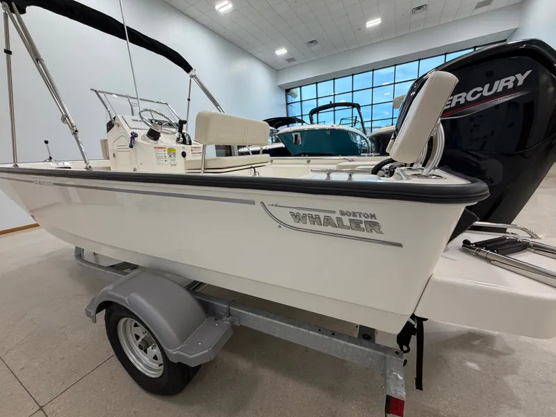 Slide: The Image of A 2027 Boston Whaler 170 Montauk on a trailer in a showroom. - 13