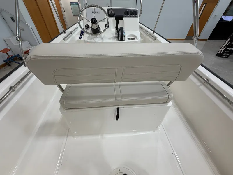 Slide: The Image of The image shows the cockpit of a Boston Whaler 170 Montauk with a white helm and bench seat. - 23