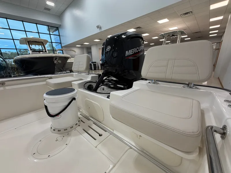 Slide: The Image of The image shows the interior of a Boston Whaler 170 Montauk boat with a Mercury engine. - 14