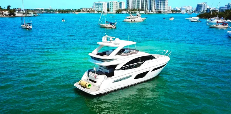 Slide: The Image of Luxurious 2018 Princess F55 yacht cruising in vibrant blue waters near a cityscape. - 4