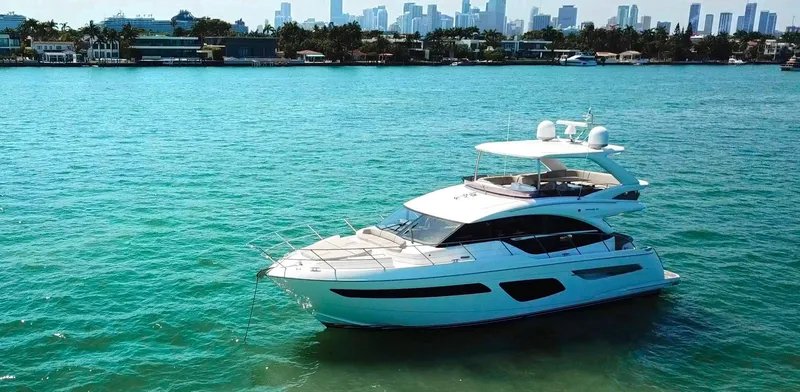Slide: The Image of Luxury 2018 Princess F55 yacht cruising on turquoise waters with city skyline backdrop. - 5