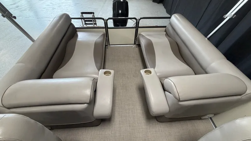 Slide: The Image of Interior view of a 2014 Premier 240 Sunsation SL with gray leather seating and cup holders. - 47