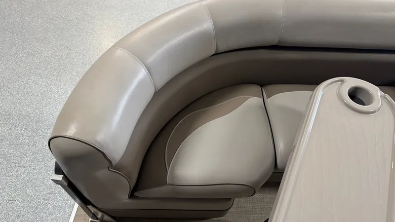 Slide: The Image of The 2014 Premier 240 Sunsation SL features an elegant curved seating area with a table. - 14