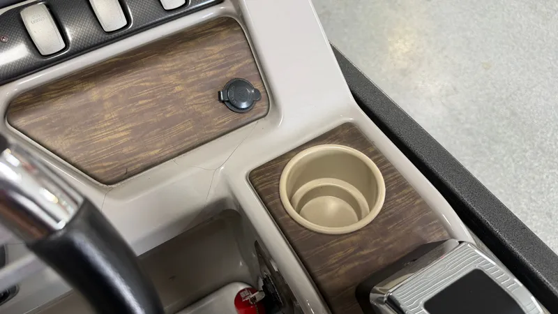 Slide: The Image of Close-up of a 2014 Premier 240 Sunsation SL dashboard with a cup holder. - 42