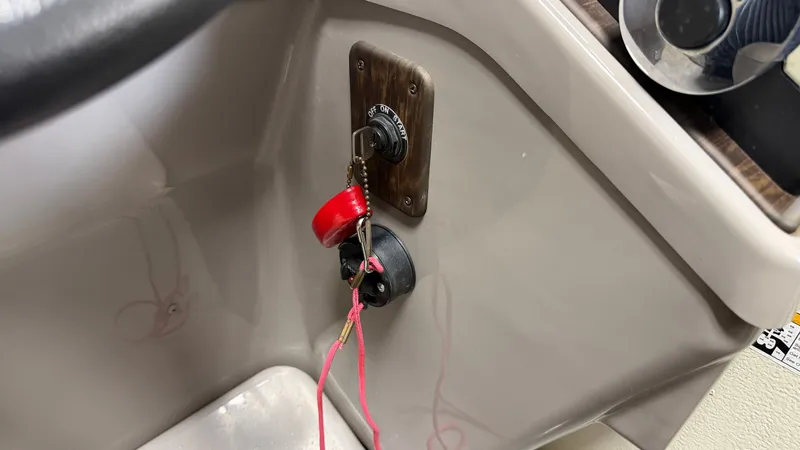 Slide: The Image of Ignition key and switch on a boat's control console. - 41