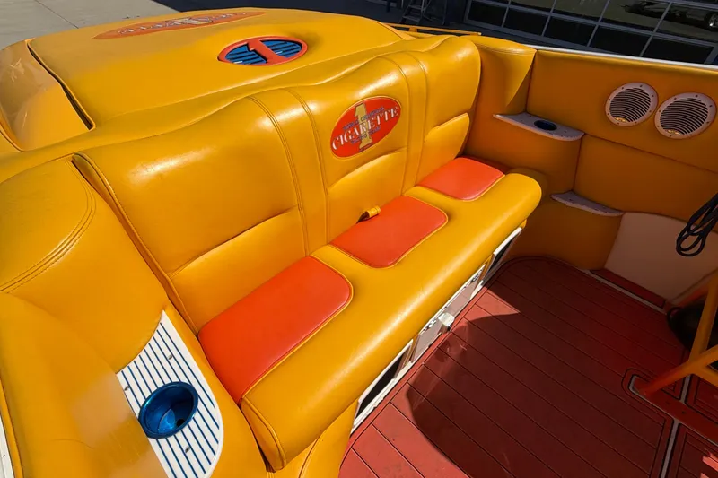 Slide: The Image of Yellow and orange seating in a 2002 Cigarette 35' Cafe Racer boat interior. - 10