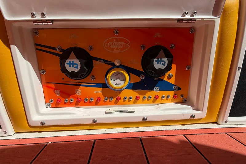 Slide: The Image of Control panel of a 2002 Cigarette 35' Cafe Racer boat with vibrant design. - 16