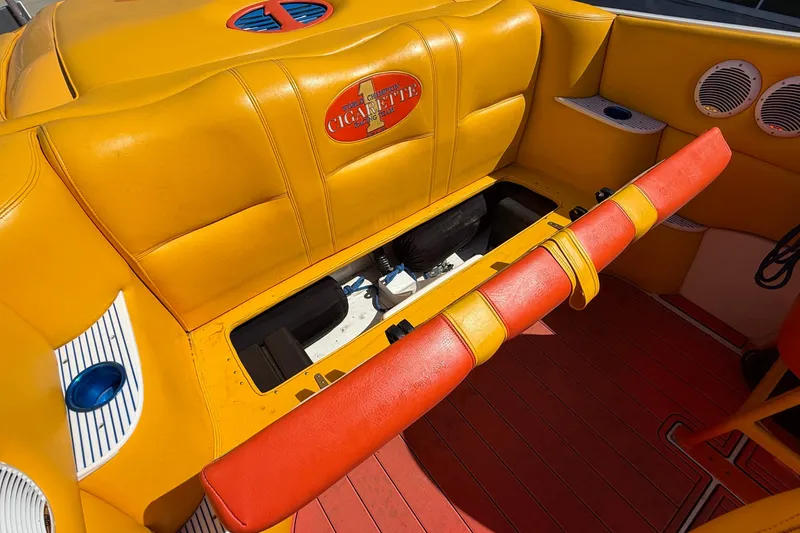 Slide: The Image of 2002 Cigarette 35' Cafe Racer boat interior with vibrant yellow and red seating. - 17
