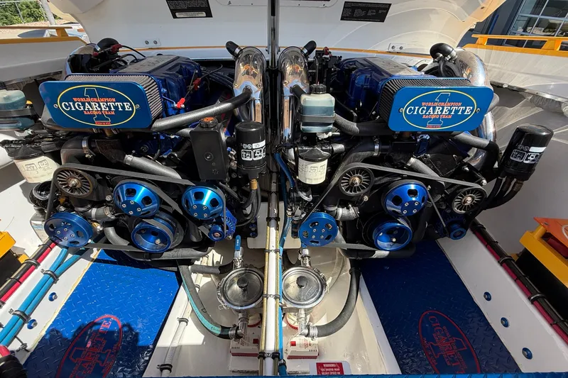 Slide: The Image of Twin engines of a 2002 Cigarette 35' Cafe Racer boat, showcasing detailed mechanics. - 19