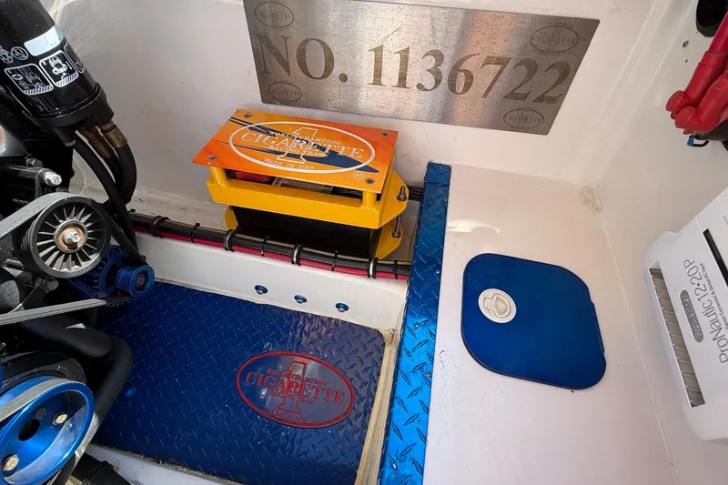 Slide: The Image of Engine compartment of a 2002 Cigarette 35' Cafe Racer boat, featuring branded components. - 22