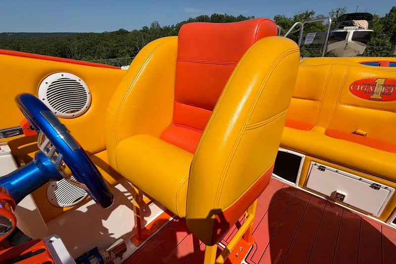 Slide: The Image of 2002 Cigarette 35' Cafe Racer boat interior with vibrant yellow and orange seating. - 27