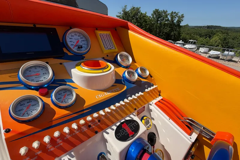 Slide: The Image of 2002 Cigarette 35' Cafe Racer dashboard with vibrant orange and yellow design, featuring multiple gauges. - 29