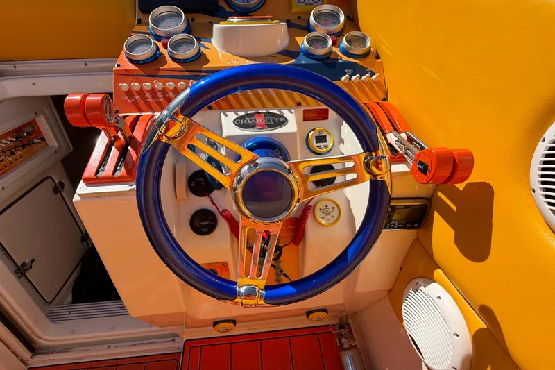 Slide: The Image of Colorful dashboard of a 2002 Cigarette 35' Cafe Racer boat with vibrant controls. - 32