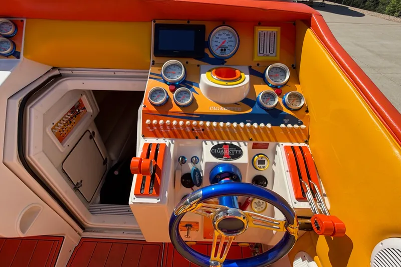 Slide: The Image of Cockpit of a 2002 Cigarette 35' Cafe Racer boat with vibrant controls and gauges. - 33