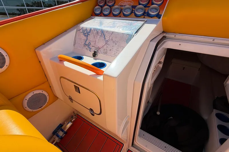 Slide: The Image of Interior of a 2002 Cigarette 35' Cafe Racer boat with vibrant yellow seating and control panel. - 35