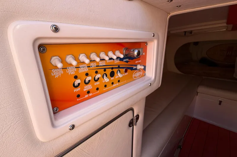 Slide: The Image of Control panel inside 2002 Cigarette 35' Cafe Racer boat cabin, featuring various switches. - 37