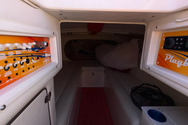 Slide: The Image of Interior of a 2002 Cigarette 35' Cafe Racer boat with control panels and seating. - 38